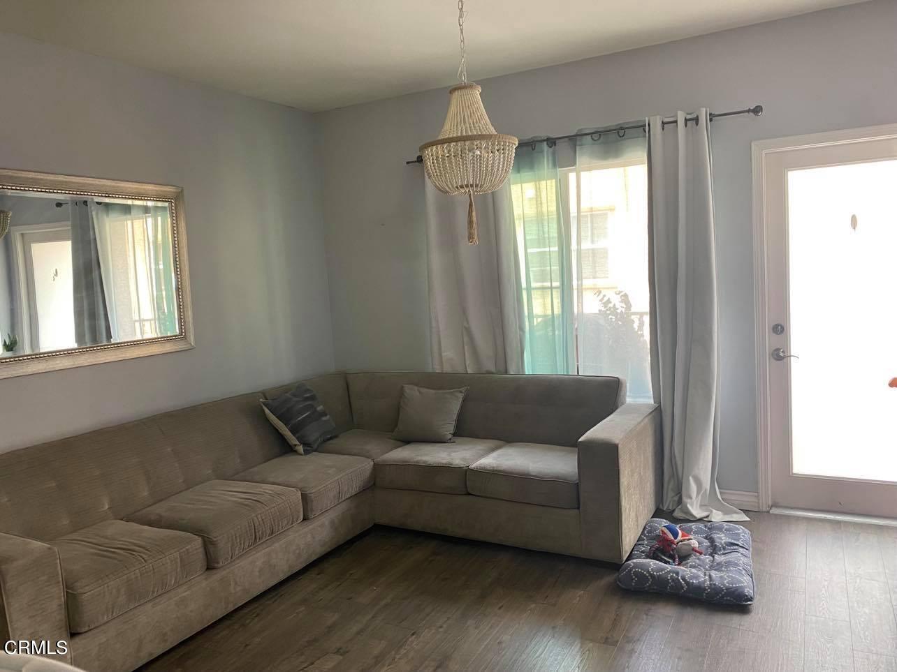 351 Riverpark Boulevard, Unit 202 Oxnard, CA 93036 - Photo 5 of 9 a living room with furniture and a window