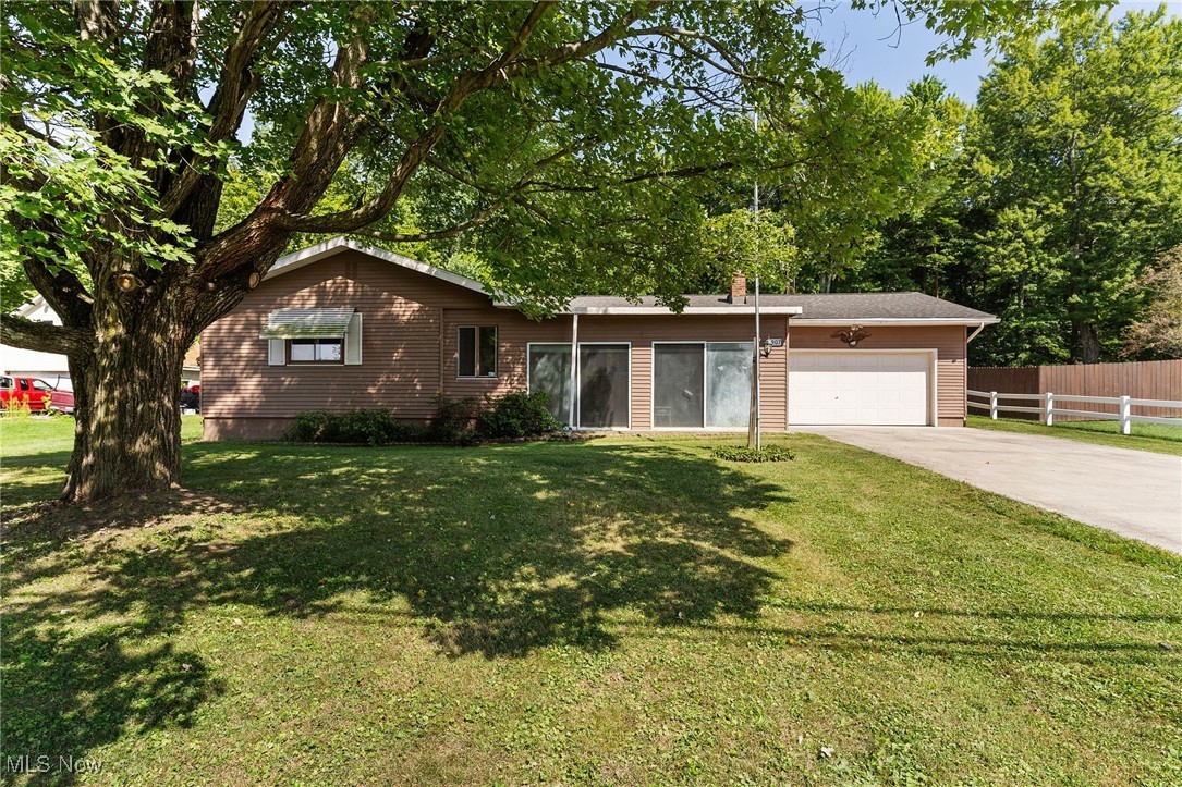 3907 Edwards Street Mineral Ridge, OH 44440 - Photo 11 of 45 Ranch-style house featuring an attached garage, concrete driveway, and a sunroom