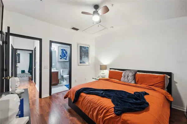 a bedroom with a bed and wooden floor