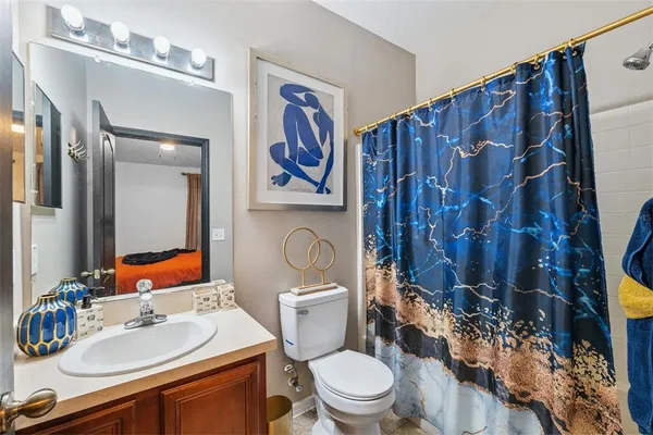 a bathroom with a toilet a sink and a mirror