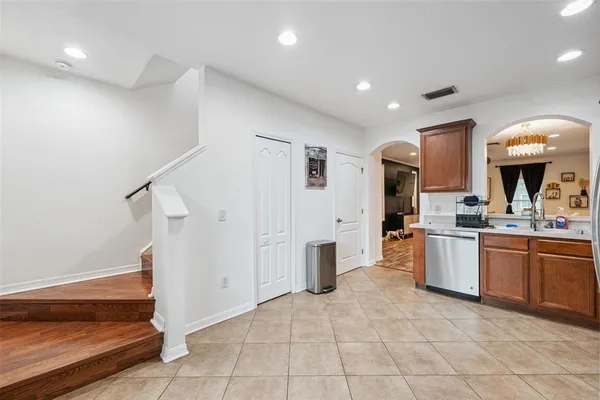 a view of a kitchen with a sink and dishwasher a refrigerator with wooden floor
