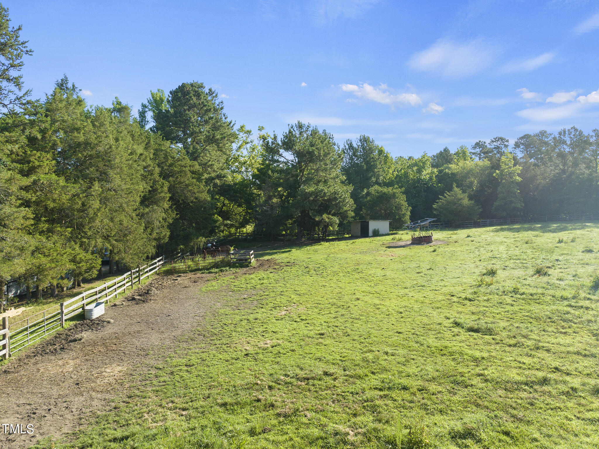 9402 Hampton Road Rougemont, NC 27572 - Photo 23 of 48 a yard with swimming pool and trees in the background