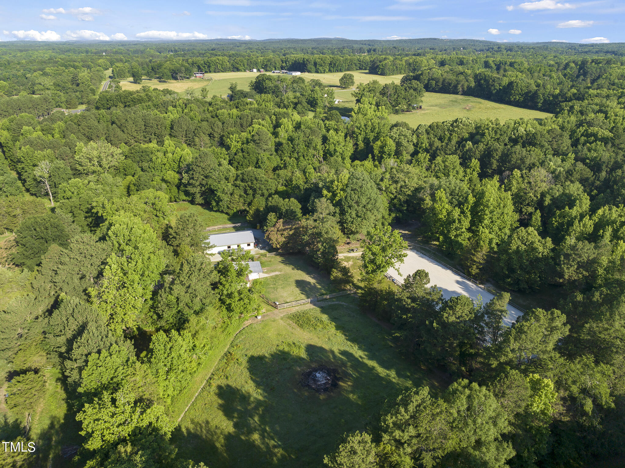 9402 Hampton Road Rougemont, NC 27572 - Photo 39 of 48 a view of a lush green forest with trees and houses