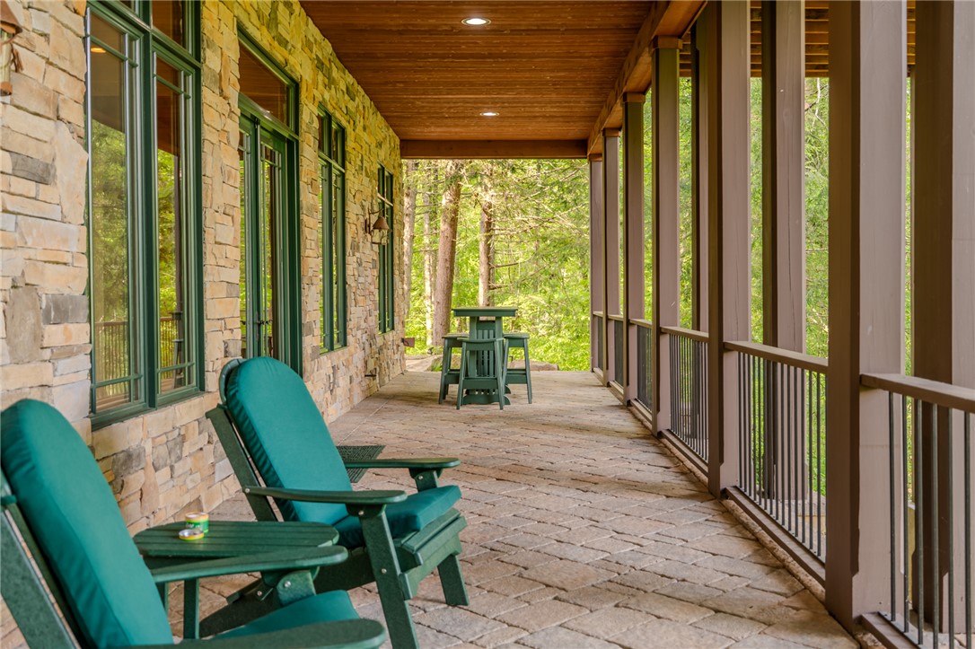 102 State Rd S-39-143 Sunset, SC 29685 - Photo 37 of 47 This inviting porch, featuring stone construction and pavers, offers a serene outdoor living space.