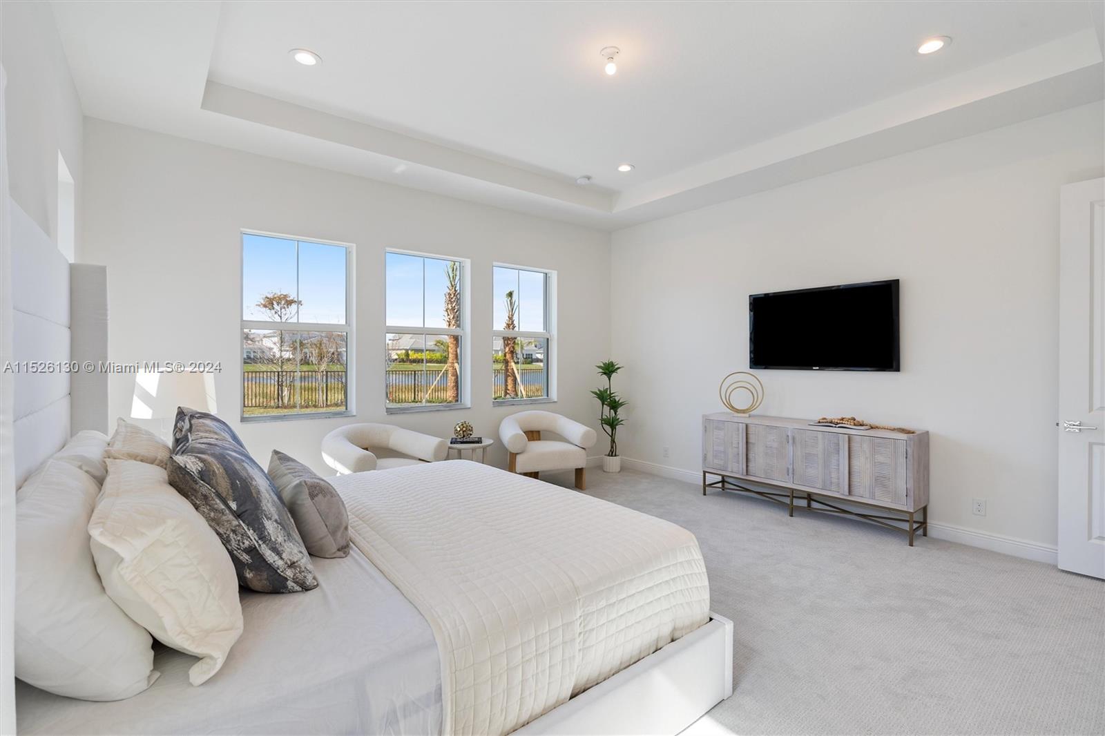 9345 Crestview Circle Palm Beach Gardens, FL 33412 - Photo 12 of 28 a bedroom with bed tv and window