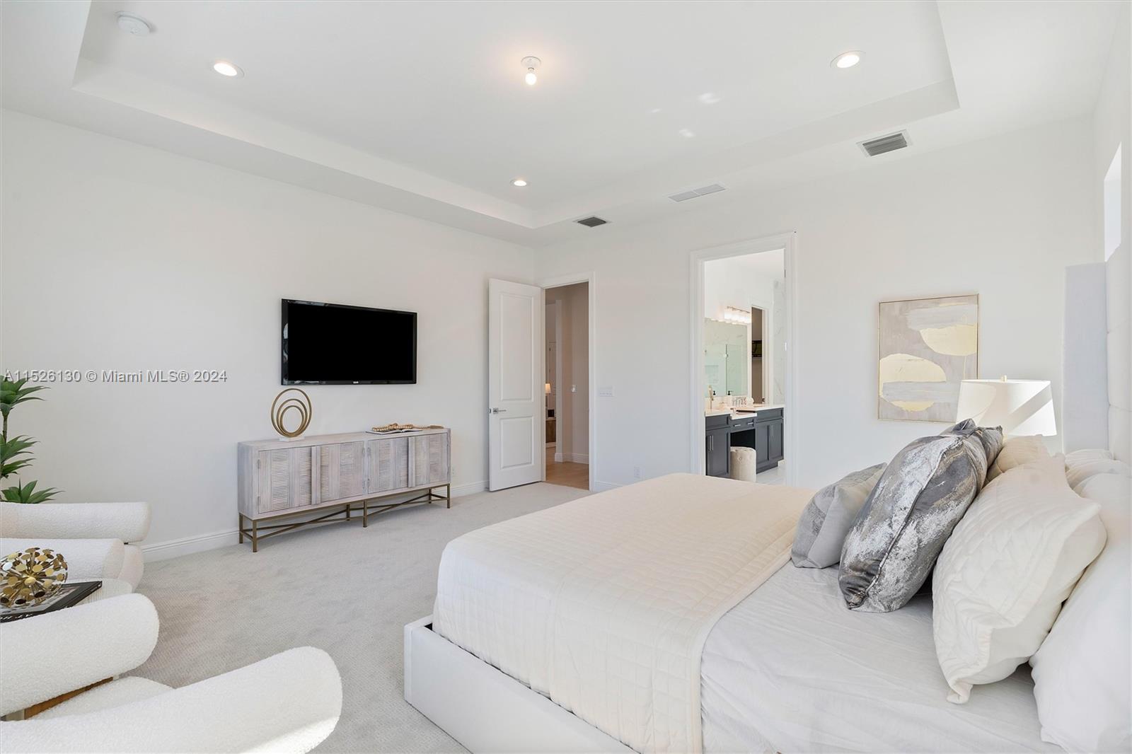 9345 Crestview Circle Palm Beach Gardens, FL 33412 - Photo 13 of 28 a bedroom with a bed and a flat screen tv