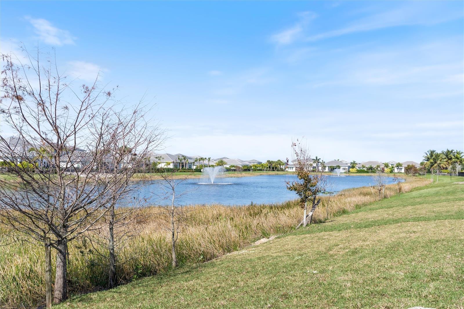 9345 Crestview Circle Palm Beach Gardens, FL 33412 - Photo 16 of 28 a view of a lake with houses in the back