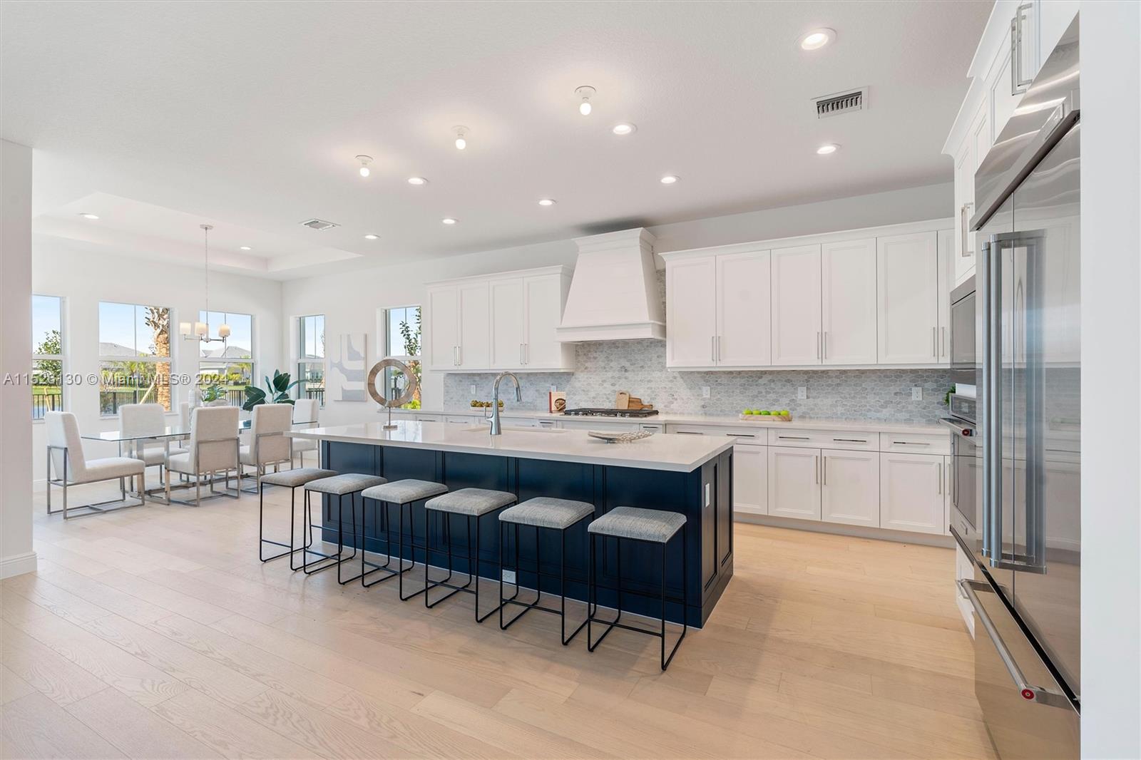 9345 Crestview Circle Palm Beach Gardens, FL 33412 - Photo 5 of 28 a kitchen with a sink and white cabinets