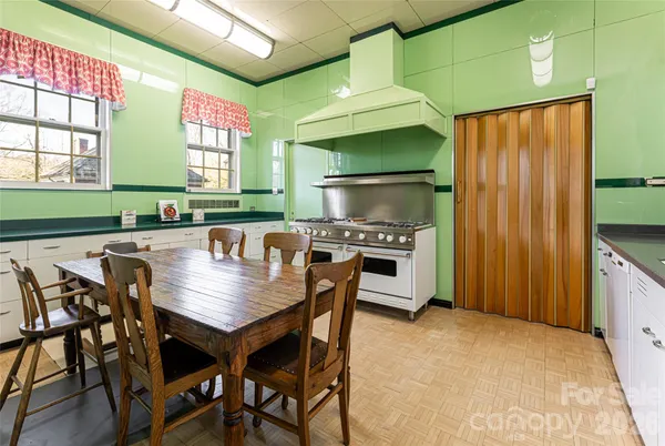 a kitchen with a table chairs and a refrigerator