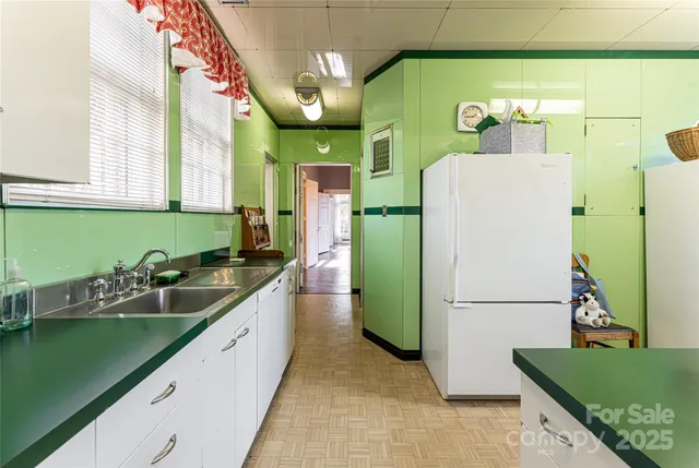 a kitchen with a refrigerator a sink and a stove