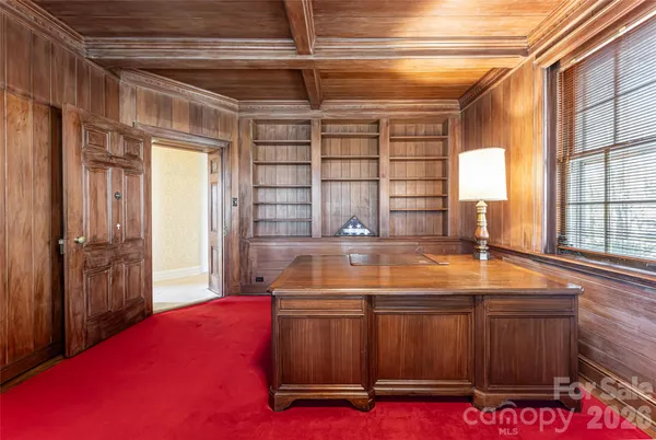 a room with pool table and windows