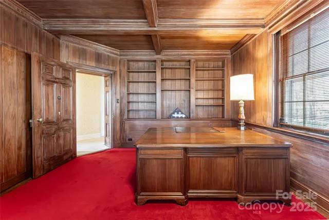 a room with pool table and windows