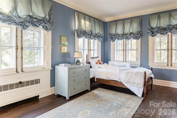 a spacious bedroom with a large bed and a window