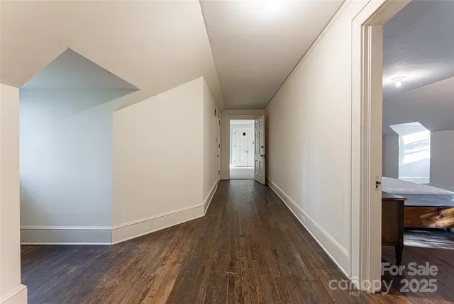 a view of hallway with wooden floor