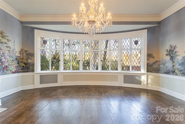 a view of wooden floor and windows in a room
