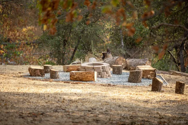 a backyard of a house with table and chairs