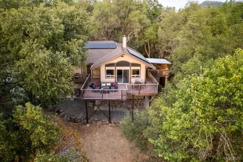 a front view of a house with a yard and balcony