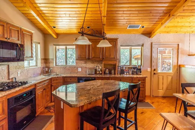 a kitchen with a stove a sink and cabinets