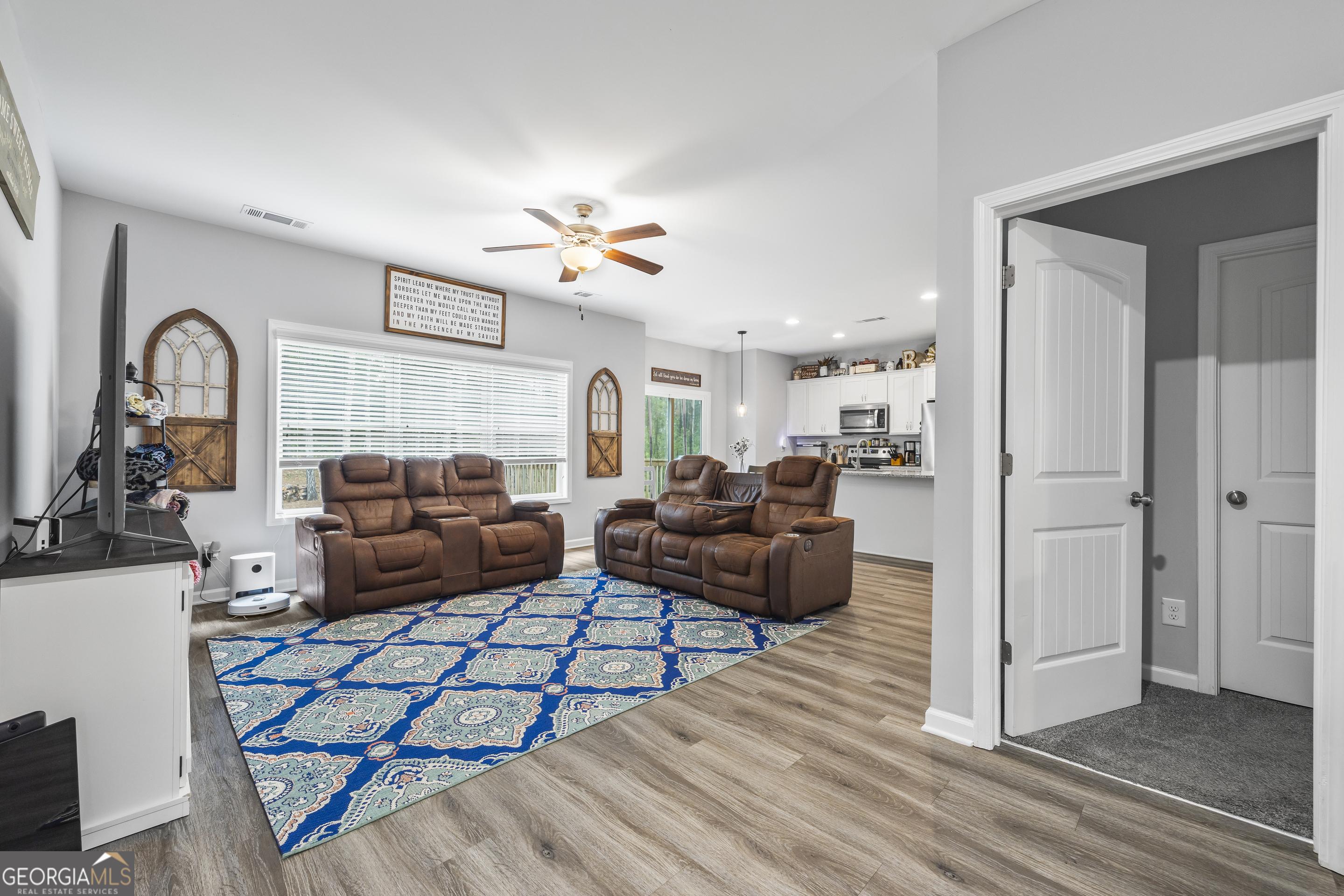 1350 Noah Crow Road Royston, GA 30662 - Photo 16 of 48 a living room with furniture a rug and a chandelier
