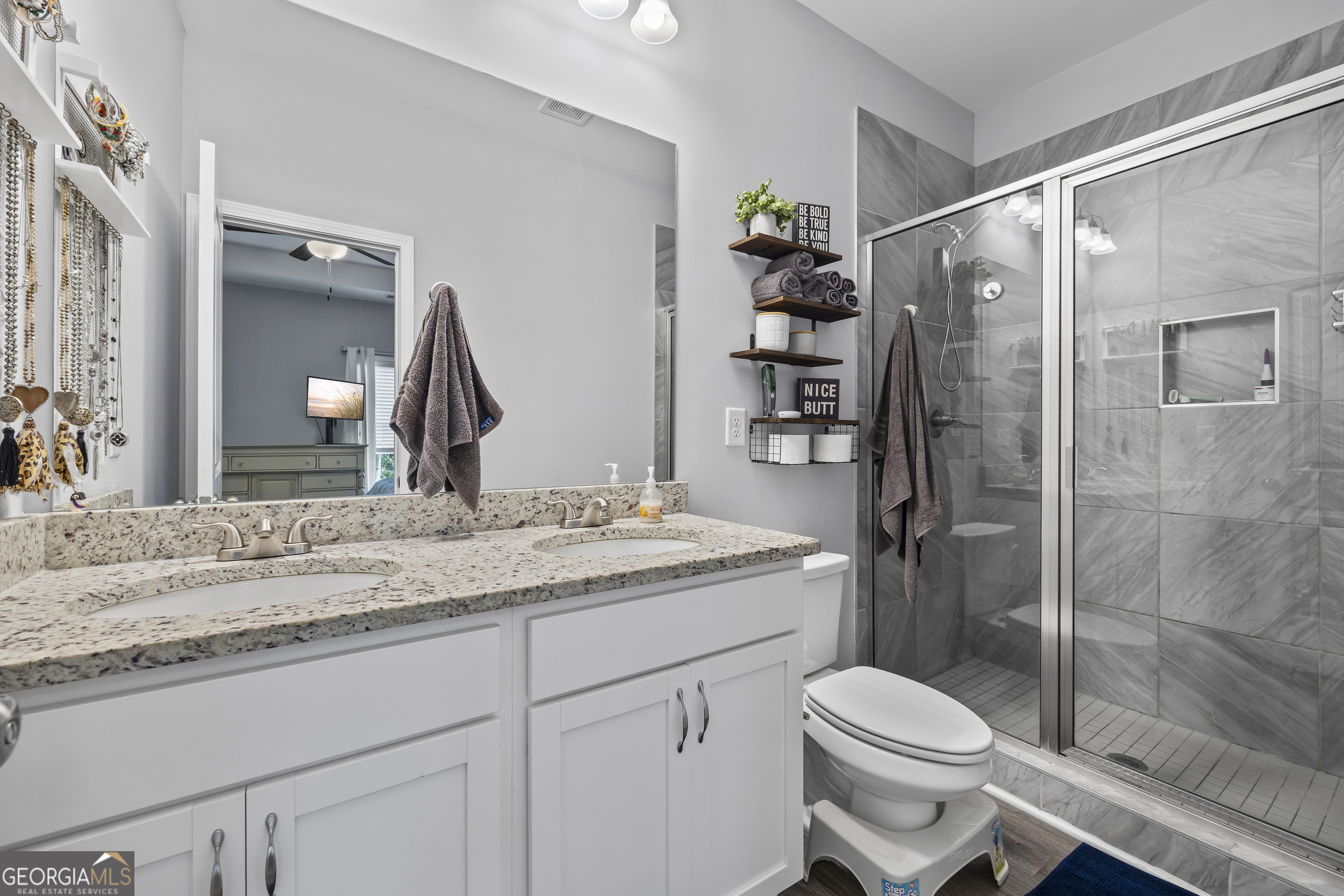 1350 Noah Crow Road Royston, GA 30662 - Photo 30 of 48 a bathroom with a granite countertop sink toilet and shower