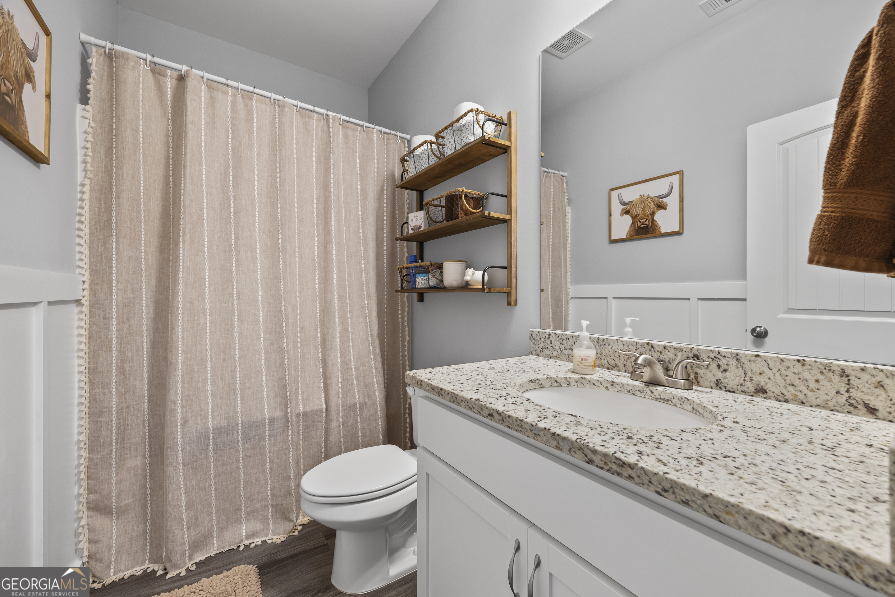 1350 Noah Crow Road Royston, GA 30662 - Photo 36 of 48 a bathroom with a granite countertop sink and a mirror