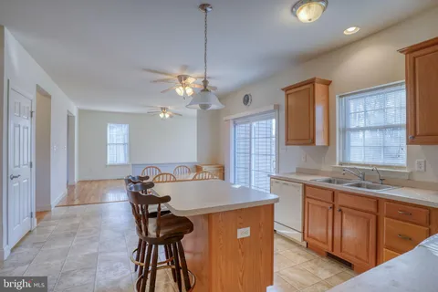 a kitchen with a table chairs and refrigerator