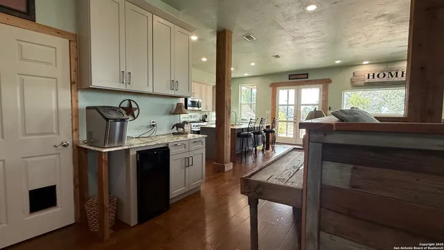 a kitchen with stainless steel appliances granite countertop a stove refrigerator sink and cabinets