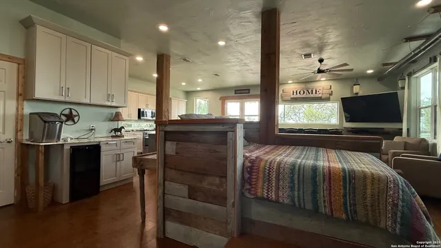 a kitchen with a sink a stove cabinets and stainless steel appliances