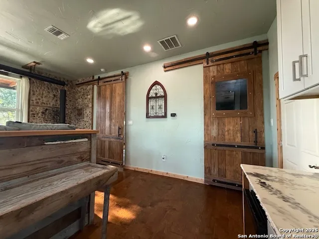 a kitchen with granite countertop a refrigerator and a stove top oven