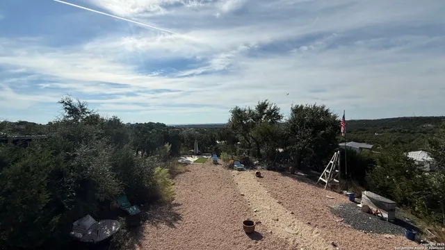 a view of a patio with a dining table and chairs with a wooden floor