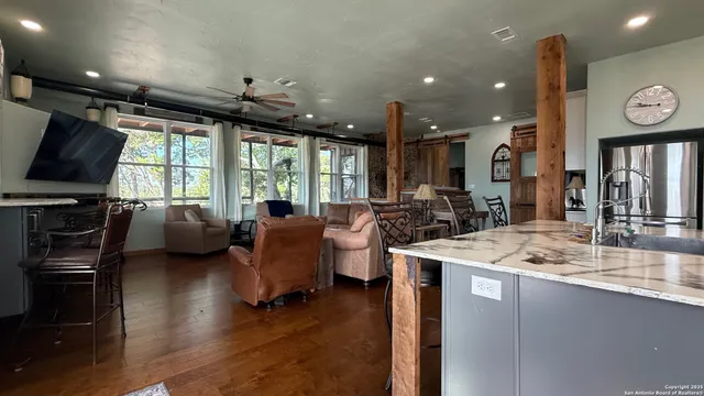 a open kitchen with sink stove and wooden floor