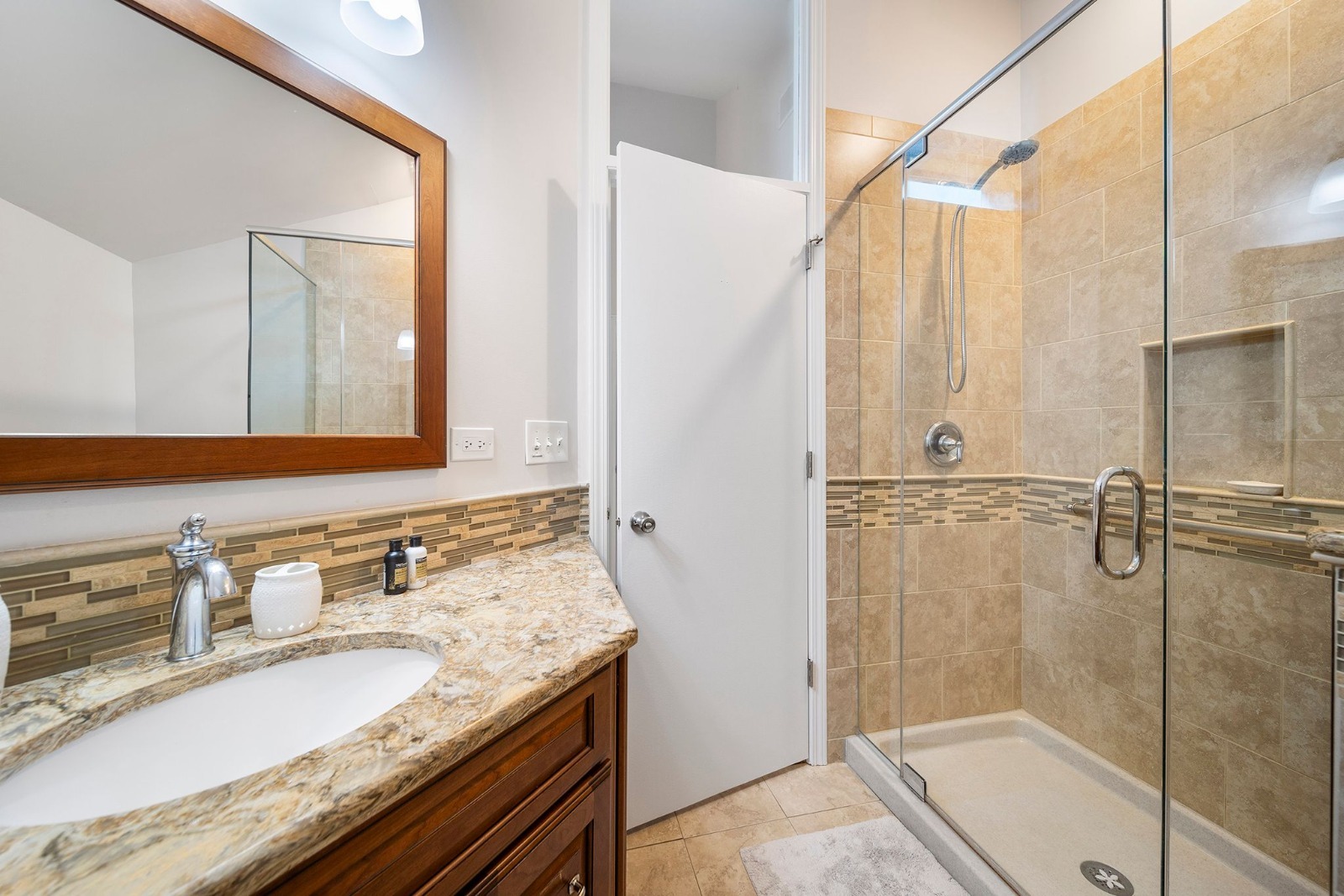 37W271 Weld Road Elgin, IL 60124 - Photo 15 of 24 a bathroom with a granite countertop sink a mirror and shower