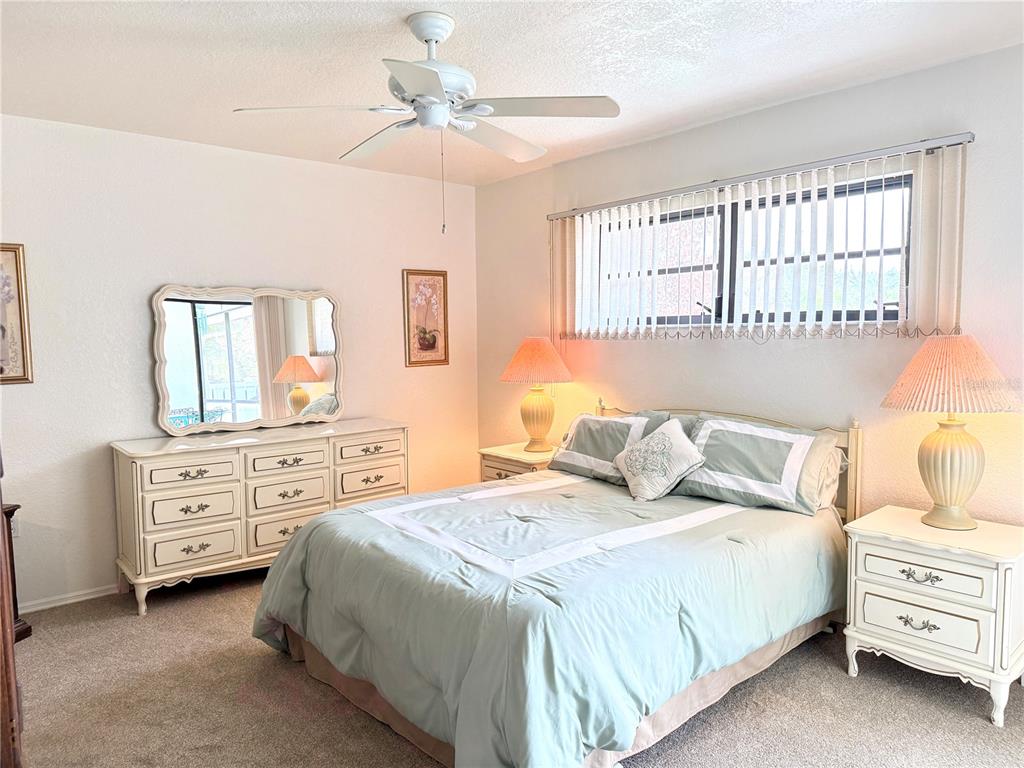 26267 Northern Cross Road, Unit 1A Punta Gorda, FL 33983 - Photo 14 of 34 a bedroom with a bed a dresser and a window