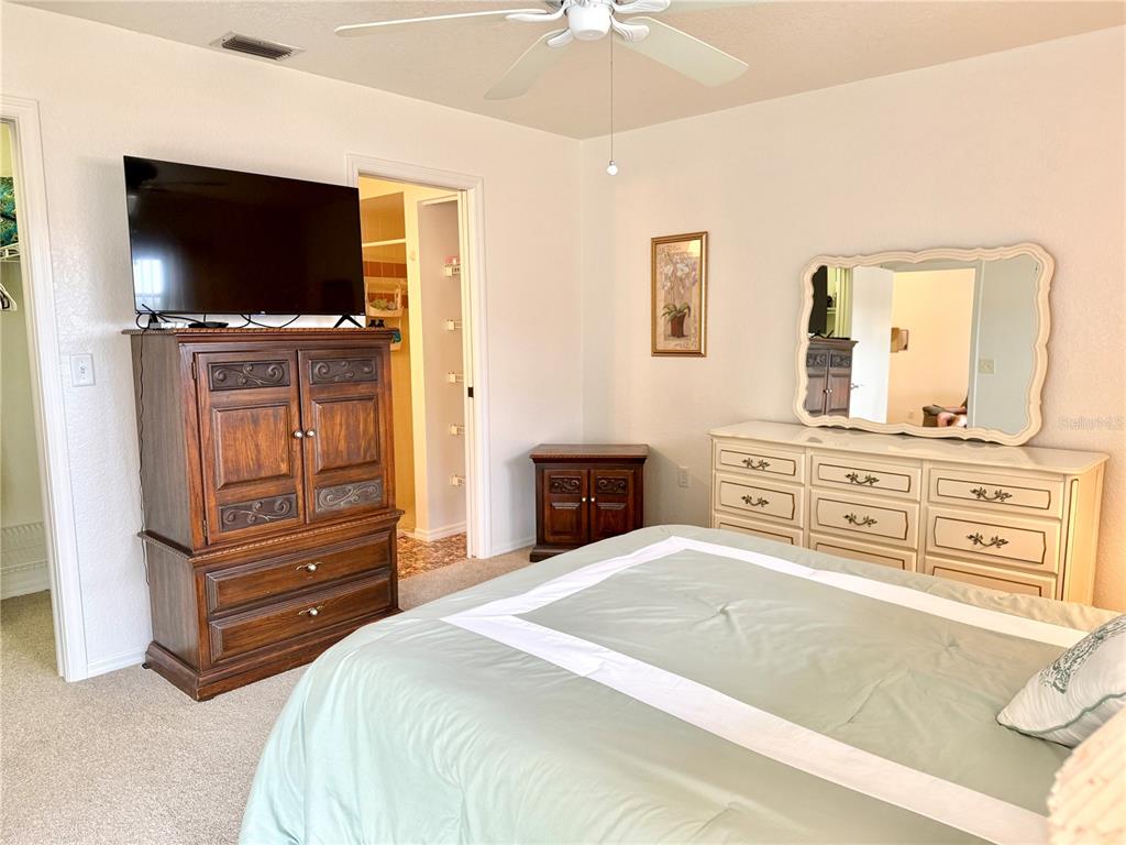 26267 Northern Cross Road, Unit 1A Punta Gorda, FL 33983 - Photo 16 of 34 a bedroom with a bed and a television