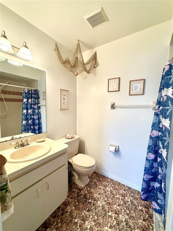 26267 Northern Cross Road, Unit 1A Punta Gorda, FL 33983 - Photo 17 of 34 a bathroom with a sink a toilet and shower