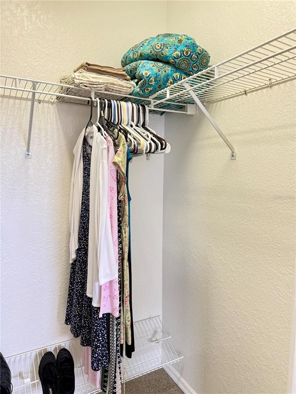 26267 Northern Cross Road, Unit 1A Punta Gorda, FL 33983 - Photo 19 of 34 a view of walk in closet with clothes and shoes