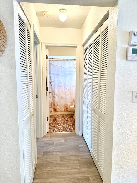 26267 Northern Cross Road, Unit 1A Punta Gorda, FL 33983 - Photo 20 of 34 a view of a hallway with wooden floor and a bathroom