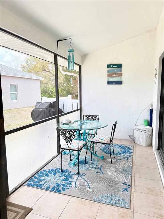 26267 Northern Cross Road, Unit 1A Punta Gorda, FL 33983 - Photo 26 of 34 a dining room with furniture and a window