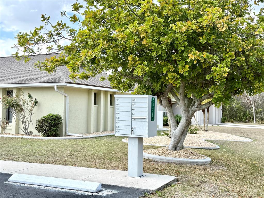26267 Northern Cross Road, Unit 1A Punta Gorda, FL 33983 - Photo 29 of 34 a front view of a house with garden