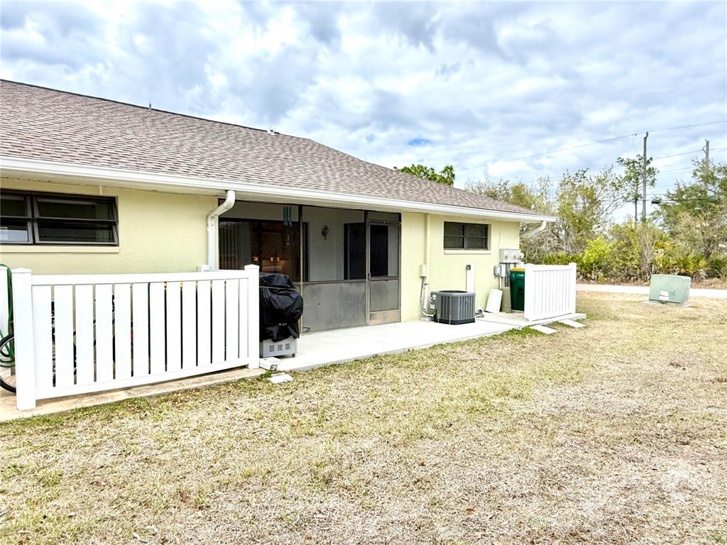 26267 Northern Cross Road, Unit 1A Punta Gorda, FL 33983 - Photo 3 of 34 a view of a house with wooden fence