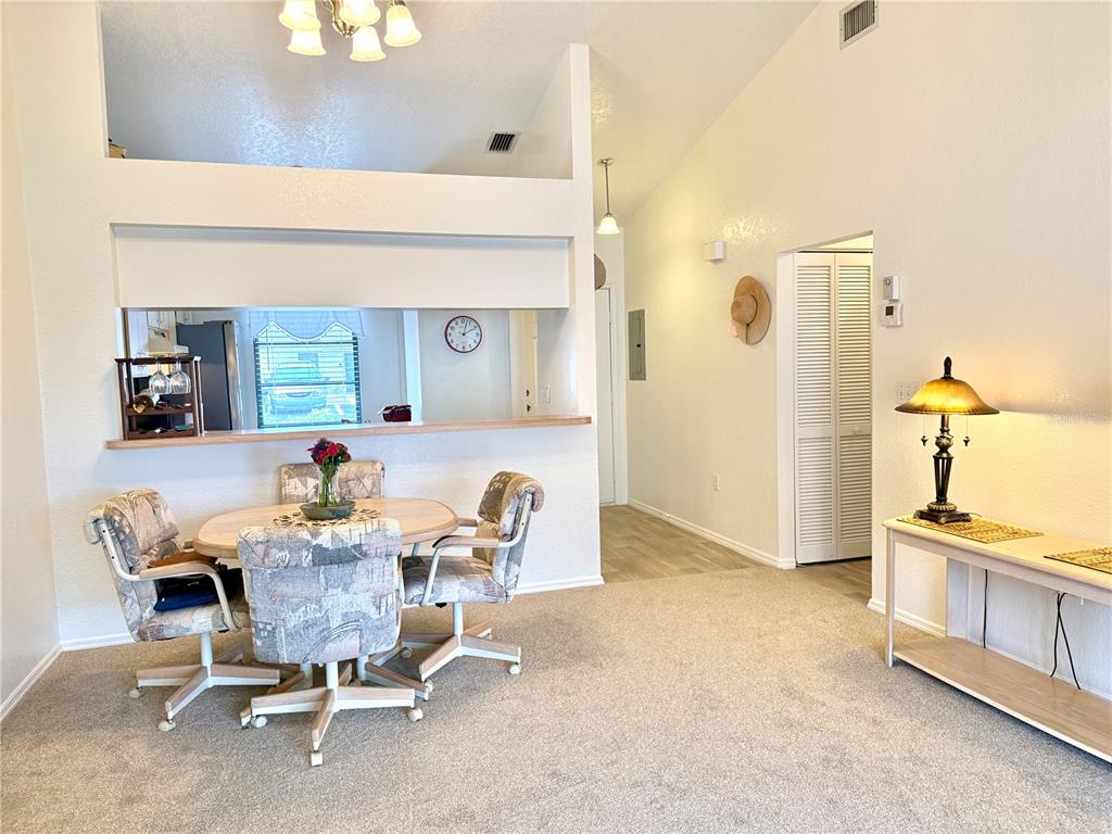 26267 Northern Cross Road, Unit 1A Punta Gorda, FL 33983 - Photo 6 of 34 a living room with furniture and a dining table