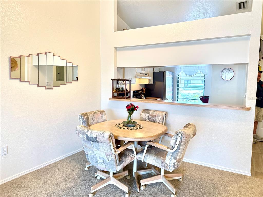 26267 Northern Cross Road, Unit 1A Punta Gorda, FL 33983 - Photo 7 of 34 a dining room with furniture and window