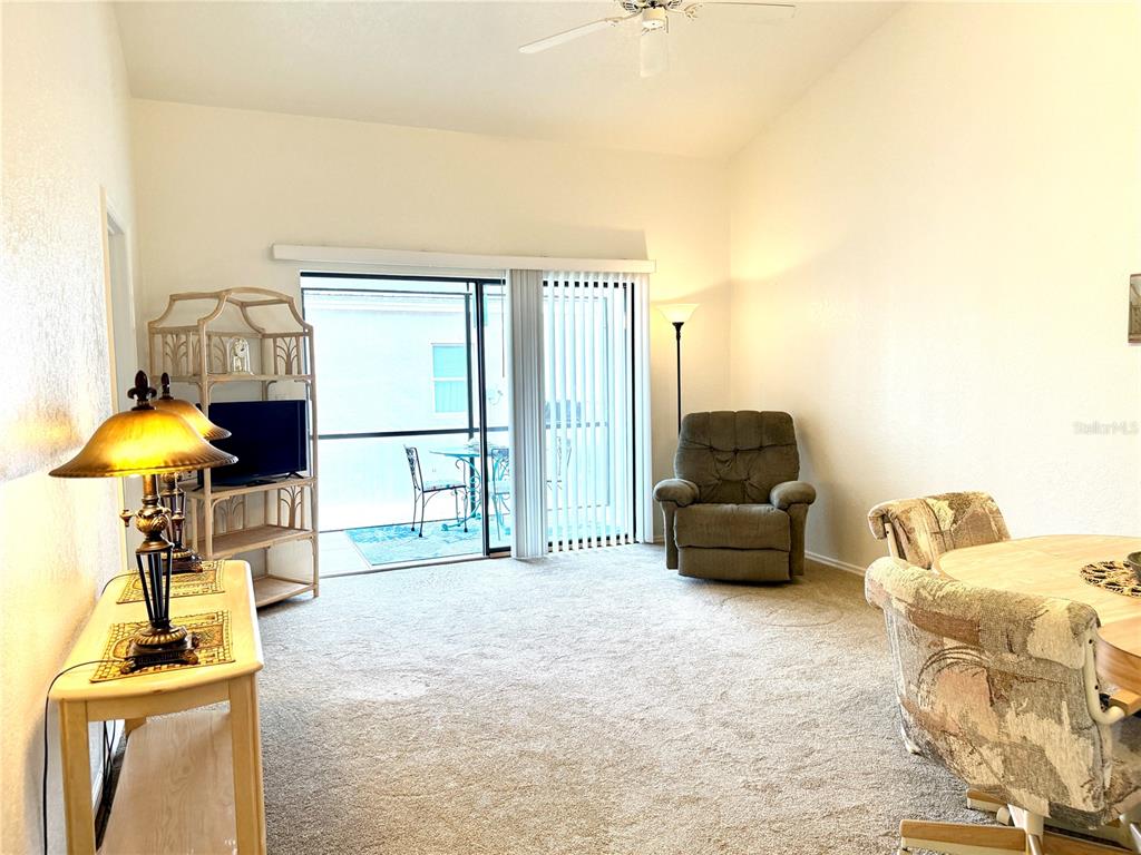 26267 Northern Cross Road, Unit 1A Punta Gorda, FL 33983 - Photo 8 of 34 a living room with furniture and a lamp