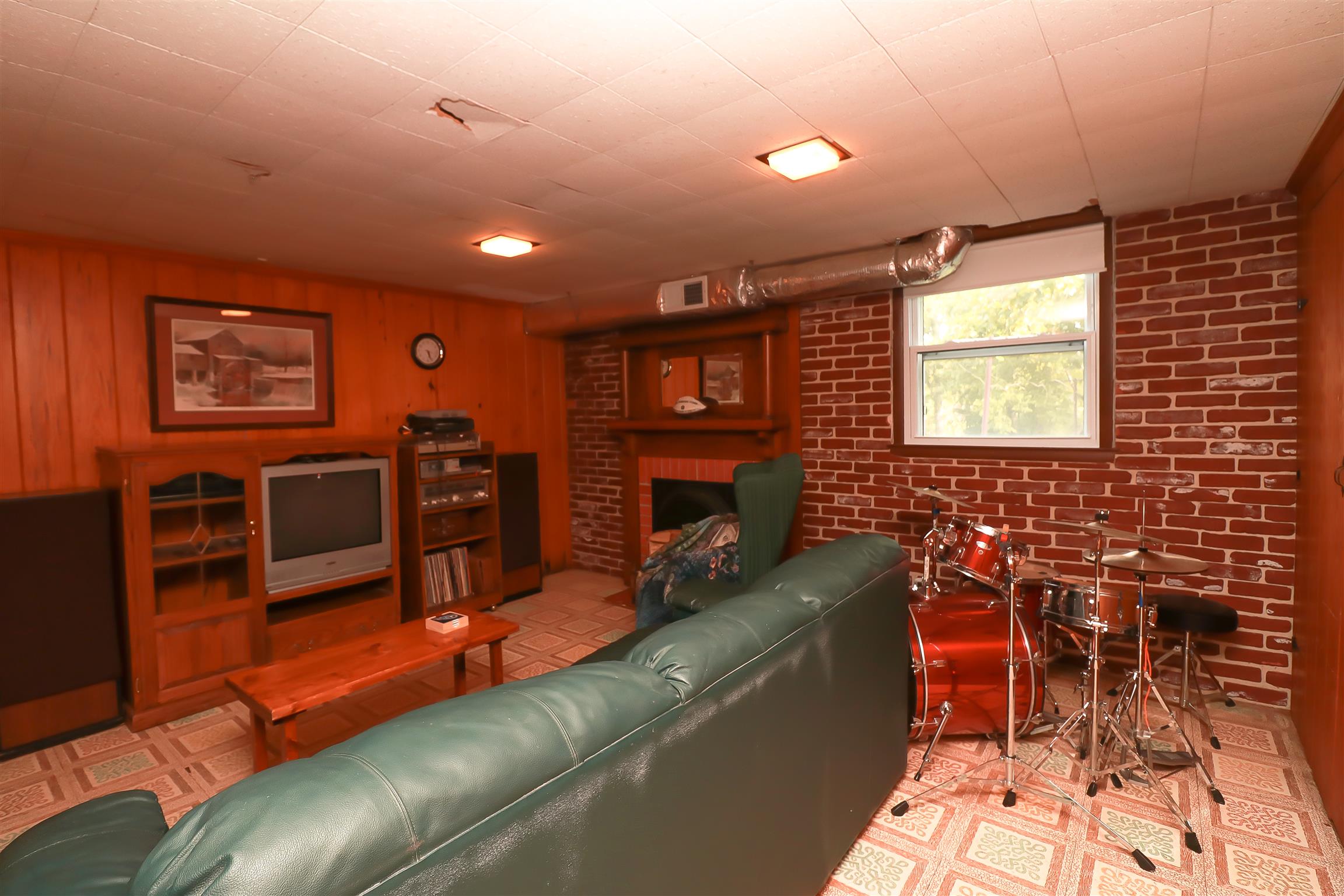 753 Reeves Road Antioch, TN 37013 - Photo 17 of 23 24x14 Basement level Bonus room / Man Cave with Brick wall & Fireplace