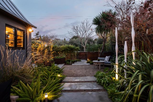 a view of a backyard with sitting area