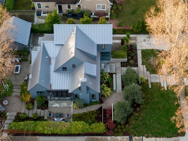 an aerial view of residential houses with outdoor space and street view