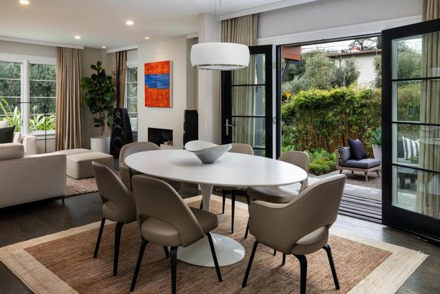 a dining room with furniture and wooden floor