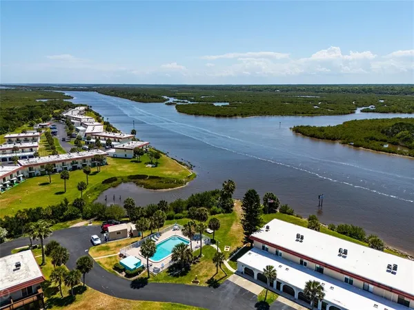 an aerial view of a house with a swimming pool outdoor seating and yard