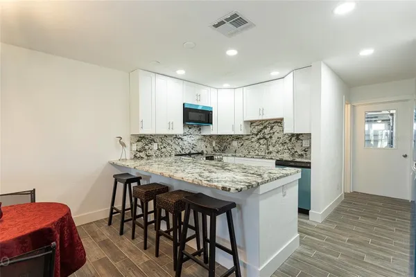 a kitchen with a table and chairs in it