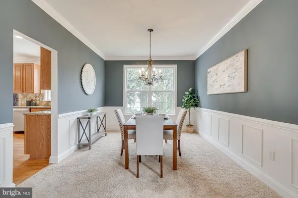a view of a dining room with furniture and chandelier